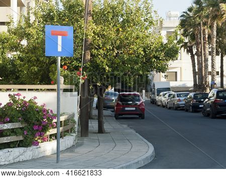 Empty City Street With Blind Alley Road Sign