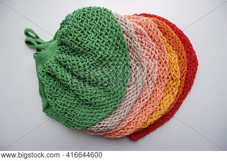 Colorful String Bags, Shopping Bag On A White Background, Photo From Above. Colorful String Bags, Co