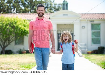 Parent And Pupil Of Primary School Go Hand In Hand. Father And Son Go To School, Education And Learn