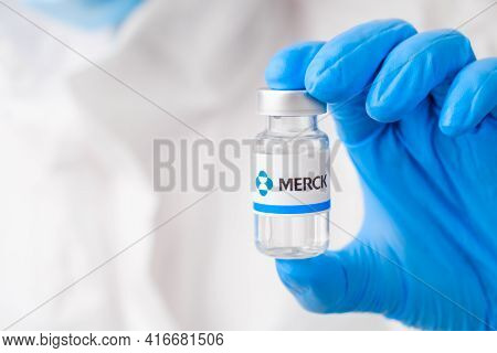 Merck Vial Or Bottle For Injection With Pharmaceuticals Or Drugs In Scientist Hands In Rubber Gloves