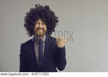 Funky Business Man In Hair Wig Pointing With Thumbs Up At Grey Copy Space