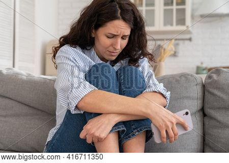 Portrait Of Depressed Young Woman Feel Upset And Sad After Phone Call, Bad News In Social Media Or S