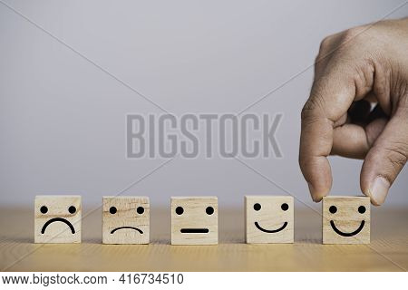 Customer Satisfaction Survey Concept, Human Face Icons Print Screen On Wooden Cube Block On Table Fo