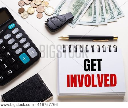 On A White Table Is A Calculator, Car Key, Cash, A Pen And A Notebook With The Inscription Get Invol