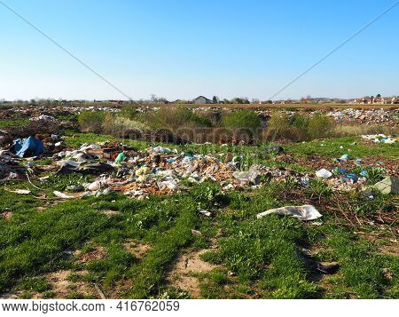 Garbage Dump Near The Village. Chaotic Unofficial Dump. Plastic, Bags, Paper, Glass, Biological Wast