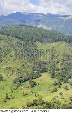 Green Valley Surrounded By The Mountains In Colombia