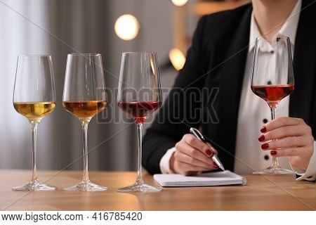 Sommelier Tasting Different Sorts Of Wine At Table Indoors, Closeup