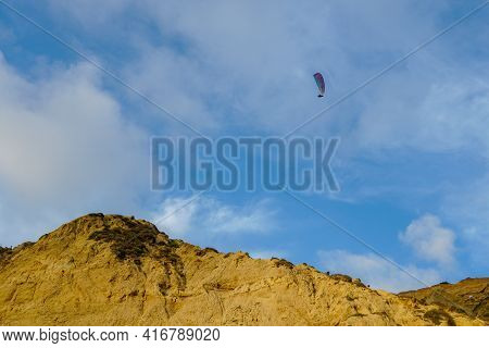 Man Doing Sport, Para-glider In The Clouded Sky. Paragliding Is An Extreme Sport And Recreation. Tor