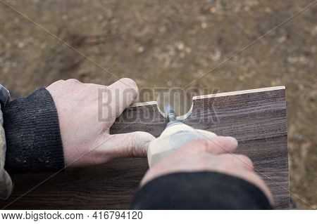 A Man Mills A Hole In A Ceramic Tile For Sanitary Ware With A Mini Electric Sander.renovation And Cl