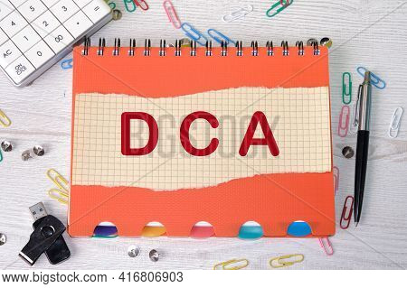 Dca Text On A Piece Of Paper For The Concept Of Business, Stocks, Finance, Banking, And Accounting..