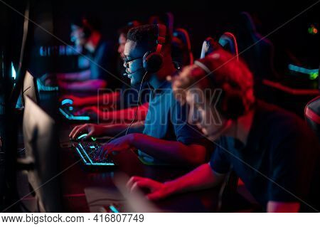 Professional Esports Players At An Online Game Tournament. The Cyber Team Plays Computers And Trains
