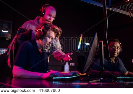 During A Computer Games Tournament, A Young Guy Is Nervous, The Coach Tells Him The Tactics Of The F