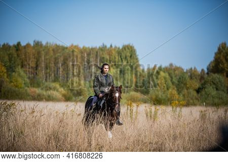 Cute Girl Equestrian Instructor Rides A Horse In An Equestrian Club