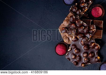 Chocolates Background. Chocolate. Assortment Of Fine Chocolates In White, Dark, And Milk Chocolate.