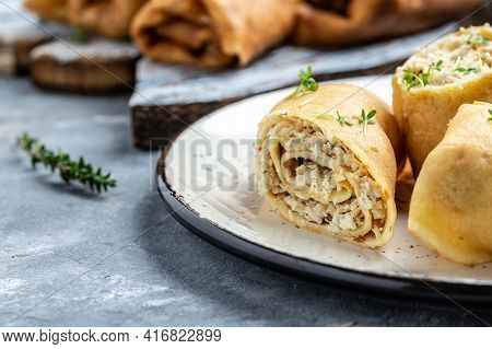 Thin Pancakes Or Crepes Stuffed Chicken Meat Served On A White Plate, Place For Text, Food Recipe Ba