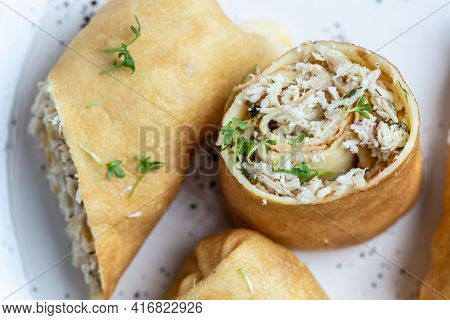 Thin Pancakes Or Crepes Stuffed Chicken Meat Served On A White Plate, Place For Text, Food Recipe Ba