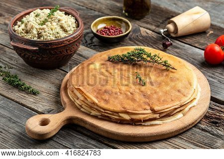 Pancakes Or Crepes Roll With The Chicken Meat. Traditional Russian Maslenitsa Festival Meal On Woode