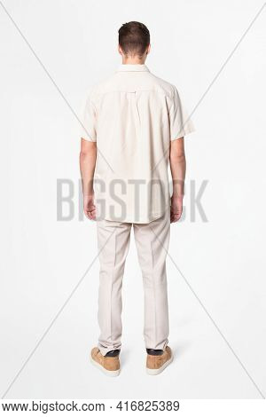 Man in beige shirt and pants casual wear fashion rear view