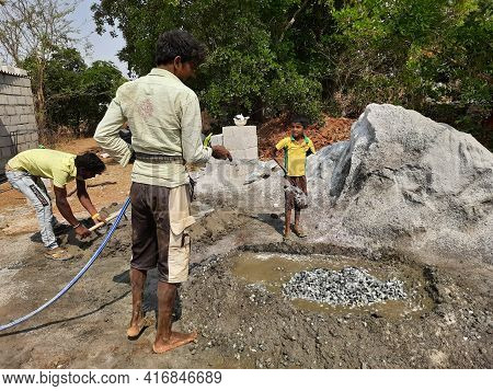 Closeup Of Indian Workers Construction Of New Building, Water Sump And Mixing Construction Material