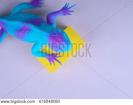 Toy Blue Dinosaur, Lizard, Iguana On A Gray Background