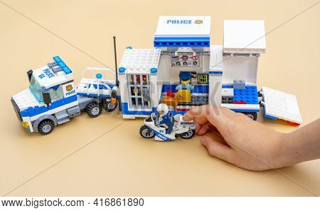 Cagnes-sur-mer, France - April 12, 2021: Boy Playing With Lego Mobile Police Truck. Toys From Bricks