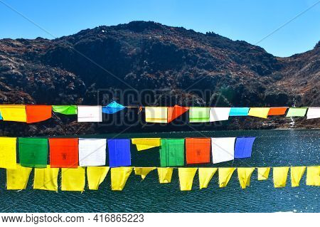 Picturesque View Of Blue Lake In Himalyan Mountain Of Sikkim With Coloured Prayer Flags