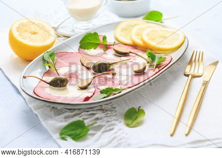 Vitello tonnato - Italian cuisine, sliced veal with tuna sauce as antipasto with capers