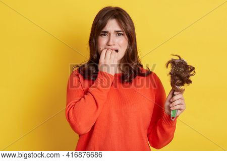 Upset European Female Wearing Orange Jumper Having Hair Loss, Looks At Camera With Sad Expression, B