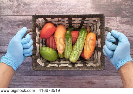 Hand In Gloves Holding A Bowl Of Fresh