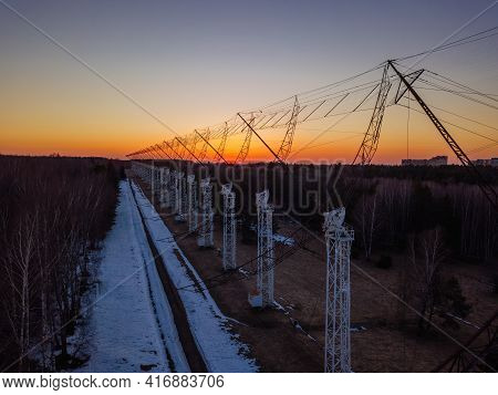Antenna Array. A Long Row Of Radio Telescopic Antennas At The Sunset