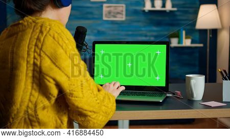 Video Blogger Reading Emails On Laptop With Green Screen Display