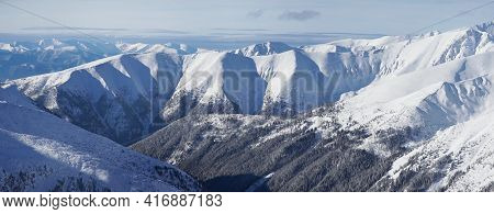 Beautiful Panoramic Shot Of Winter Mountain Peaks Covered In Snow During The Winter Season Against T