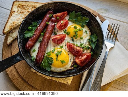 English Breakfast With Eggs, Tomatoes And Sausage