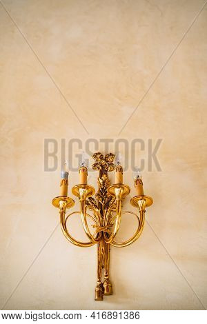 Gold Sconce With Four Electric Candles On The Wall. Gold Sconce Vintage Wall Candles