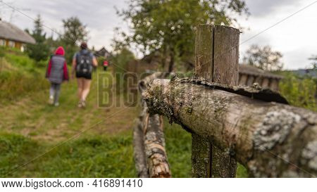 Hikers With Backpacks Climb Up Mountain Landscape