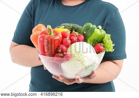 A Fat Woman Holds Fresh Organic Vegetables In A Clear Glass Bowl. The Concept Of Losing Weight Eat H