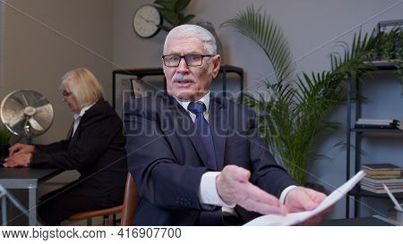 Irritated Elderly Man Boss Raising Hands In Questioning Gesture Why What In Office Room. Elderly Ent