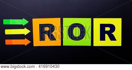 Bright Multi-colored Paper Stickers On A Black Background With The Text Ror