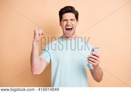 Portrait Of Nice Cheerful Overjoyed Guy Influenzer Using Device Having Fun Rejoicing Smm Isolated Ov