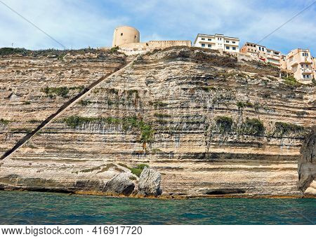 View Of Bonifacio Town In Corsica Island In France And The Long Stairway On The Rock