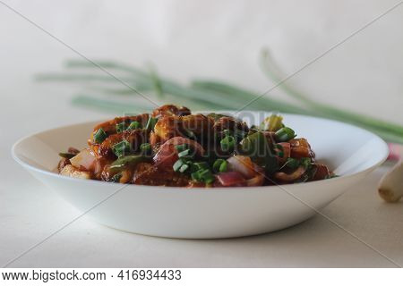 Air Fried Cottage Cheese Cubes And Baby Corn Prepared With Chilli Sauce. It Is An Indo Chinese Dish,
