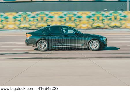 Moscow , Russia - March 2021: Black Bmw 5 Series Car On The City Road. Fast Moving Vehicle On The St