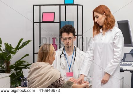 In A Physicians Office, A Nurse Practitioner Is Taking The Blood Pressure Of A Fifty-year-old Female
