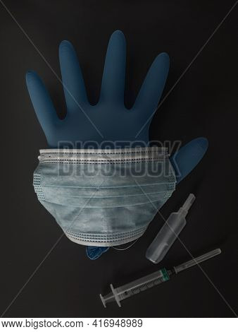 Medical Mask Glasses Syringe Vaccine In An Ampoule Gloves Lie On A Wooden Table