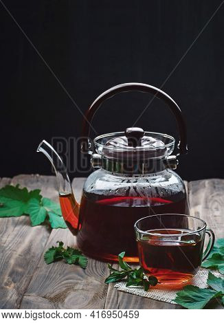 Herbal Tea With Mint And Lemon. Tea Cup And Teapot On  Table. Cup Of Aromatic Herbal Tea.tea Time. G