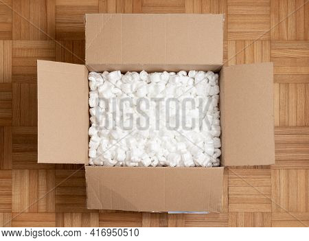 A Cardboard Box With Packing Styro Foam Pellets Top View