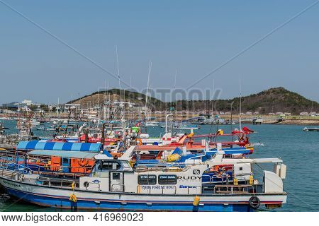 Pyeongtaek, South Korea; April 6, 2021:row Of Tour Boats And Fishing Trawlers Docked At Jeongok Mari