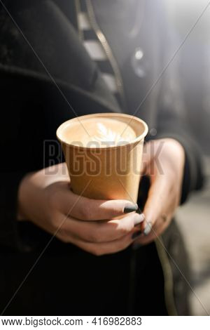 Cup With Coffee In Girls Hands Morning Background. Paper Cup With Cappuccino And The Girls Hand.