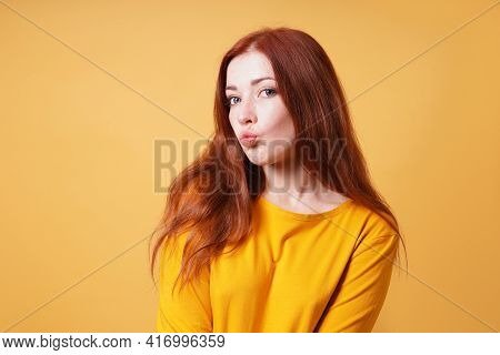 Young Woman Puckering Her Lips For A Kiss Or Duckface Facial Expression