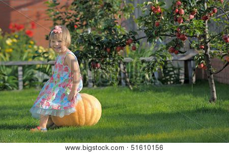 Smiling Girl On Pumpking Over Apple Tree On A Farm